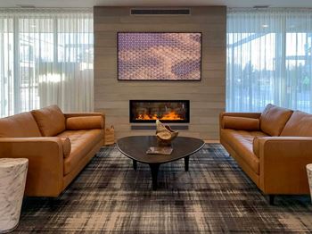 a fire place and seating area in the clubroom of Brynwood at Wilderness Ridge in Lincoln, NE 68512